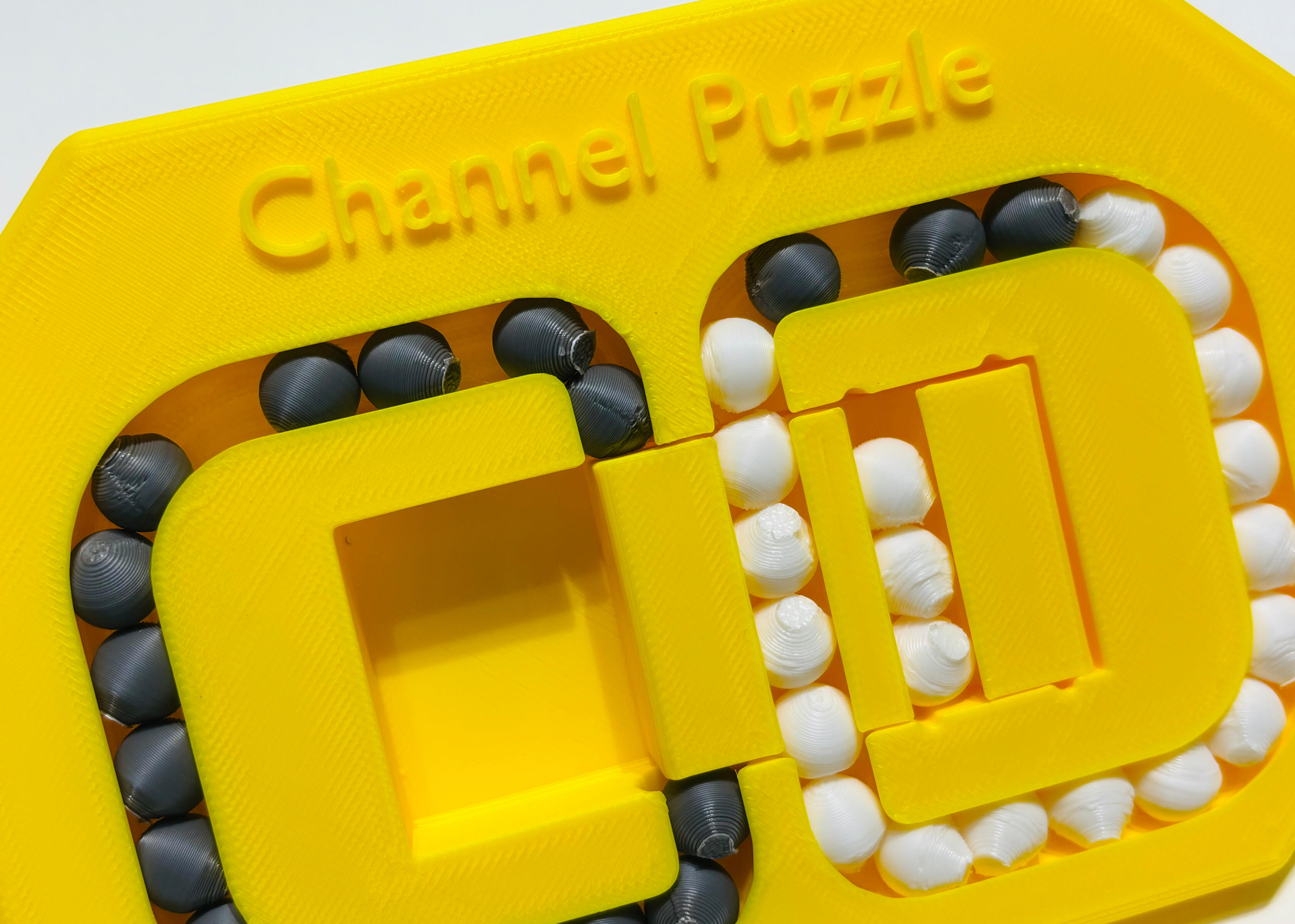 3D Printed Puzzle Game: Players need to move the central part to place beads of the same color on one side.